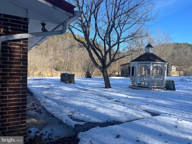 yard covered in snow with a gazebo