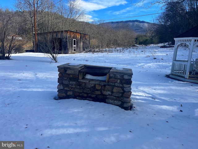 yard layered in snow with a mountain view