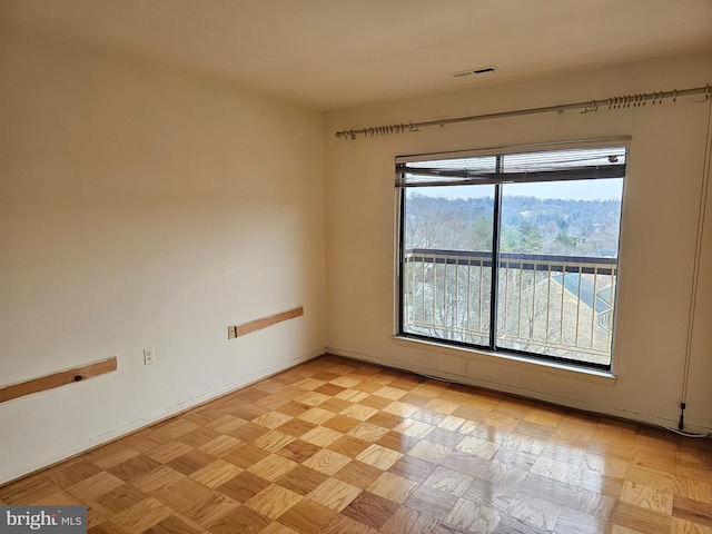 spare room with light parquet floors