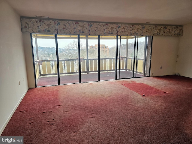 carpeted spare room with a water view