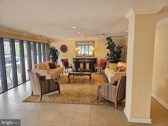 living room featuring decorative columns, crown molding, and light tile patterned floors