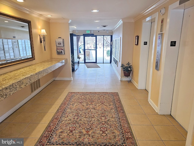 hall with light tile patterned flooring, elevator, ornamental molding, and a mail area