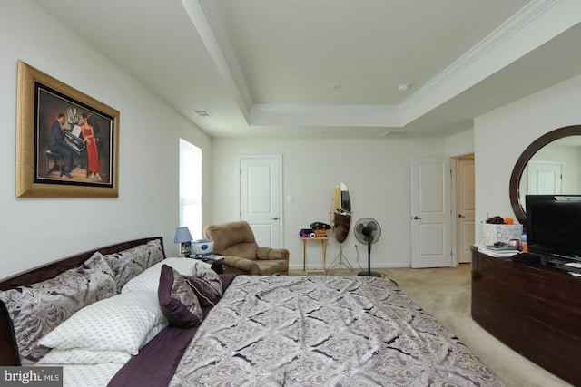 carpeted bedroom featuring ornamental molding and a raised ceiling