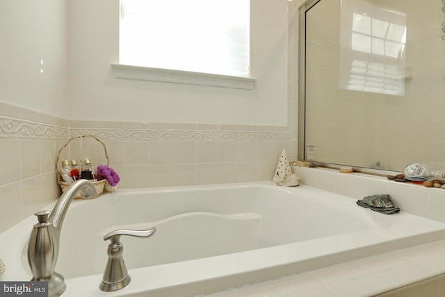 bathroom with tiled tub