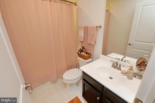 bathroom with tile patterned flooring, vanity, and toilet