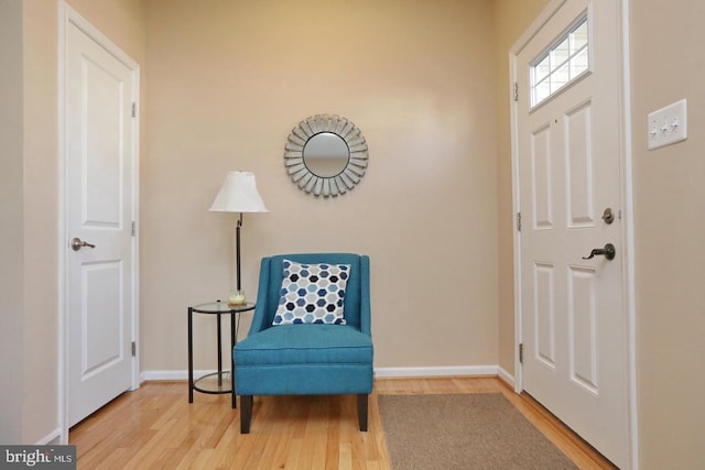 sitting room with wood-type flooring