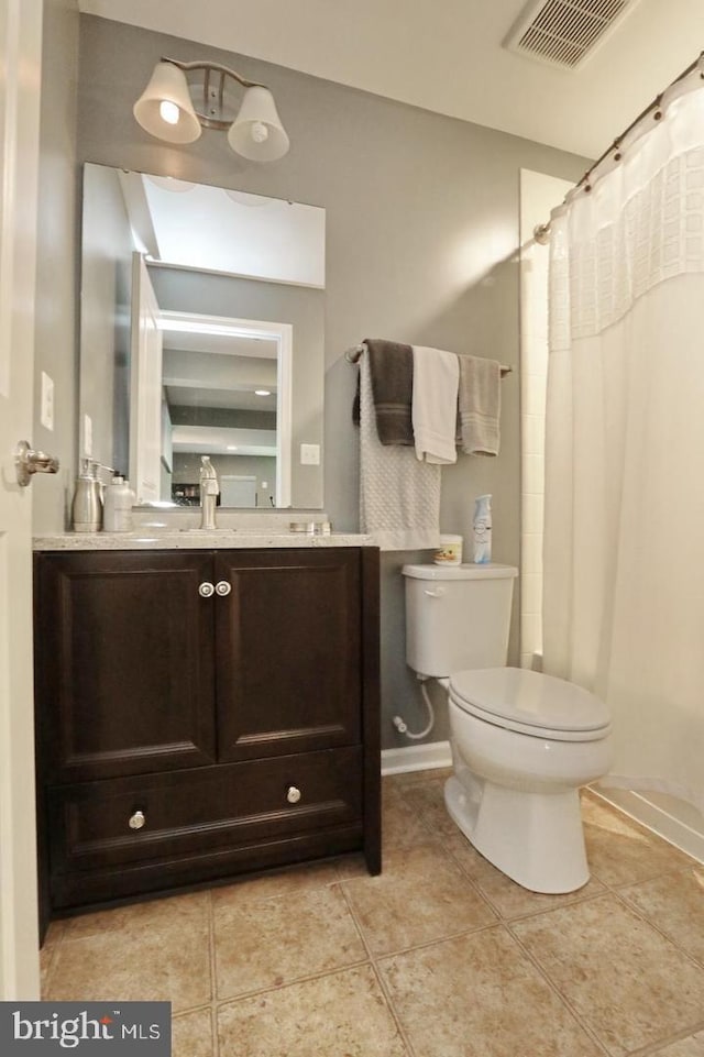 bathroom with a shower with shower curtain, vanity, toilet, and tile patterned flooring