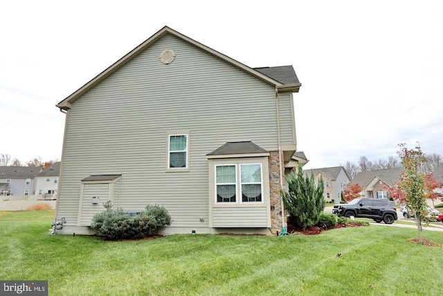 view of property exterior featuring a lawn