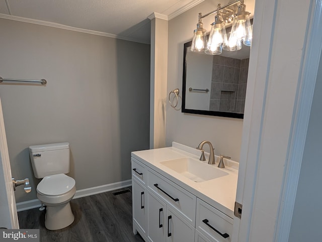 bathroom with ornamental molding, wood-type flooring, toilet, and vanity