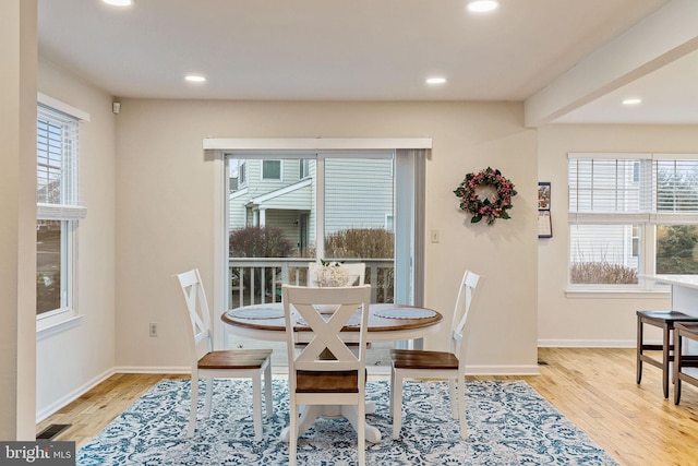 dining space with plenty of natural light and light wood-type flooring