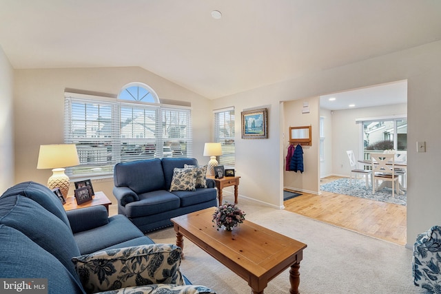 carpeted living room with vaulted ceiling