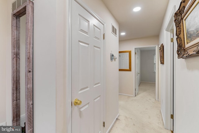 hallway featuring light carpet