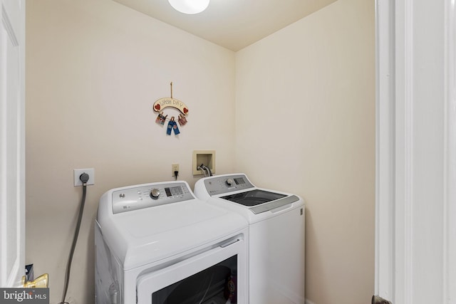 clothes washing area with washing machine and clothes dryer