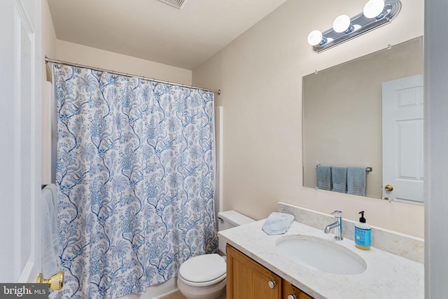 bathroom with vanity, walk in shower, and toilet