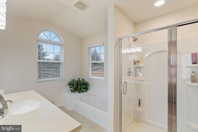 bathroom featuring lofted ceiling, sink, plus walk in shower, and a healthy amount of sunlight