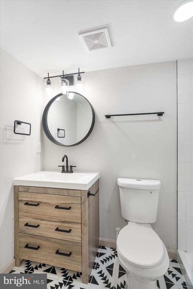 bathroom featuring vanity and toilet