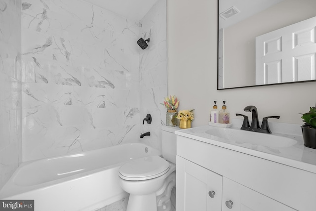 full bathroom featuring vanity, tiled shower / bath combo, and toilet