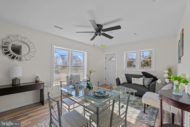 dining room with wood-type flooring and ceiling fan