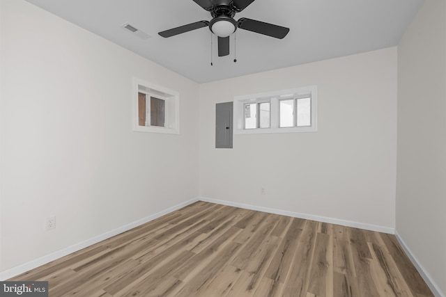 unfurnished room featuring ceiling fan, electric panel, and light wood-type flooring