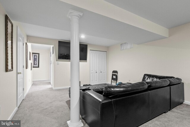 living room featuring decorative columns and light carpet