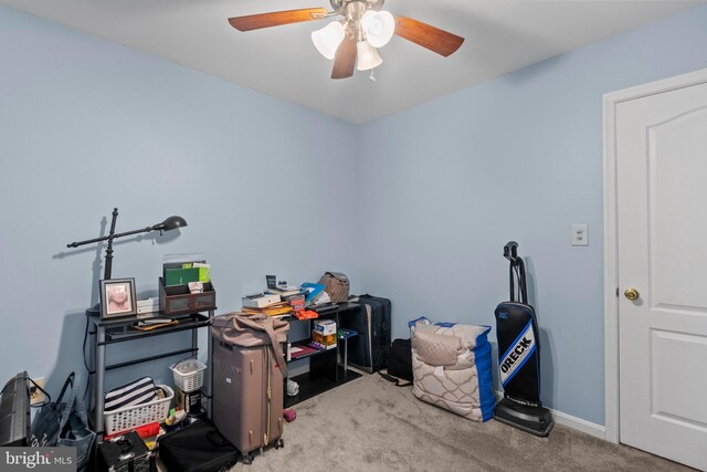 carpeted office with ceiling fan