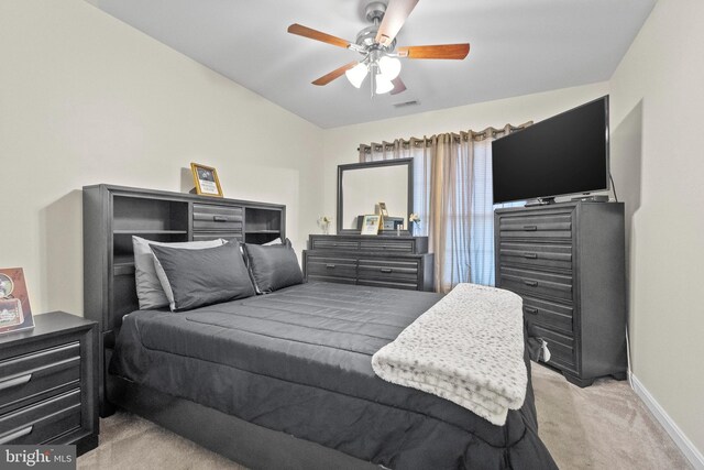 bedroom with light colored carpet and ceiling fan