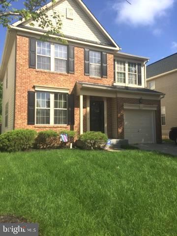 view of front of home with a garage and a front yard