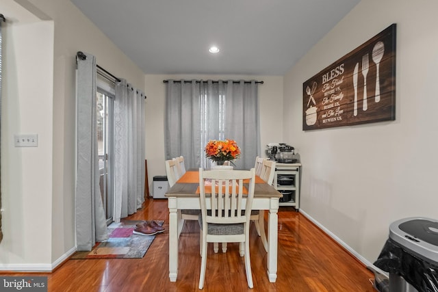 dining space featuring wood-type flooring