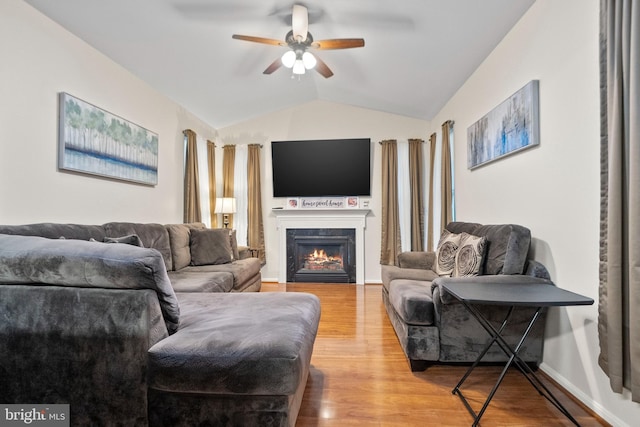 living room featuring hardwood / wood-style flooring, ceiling fan, and lofted ceiling