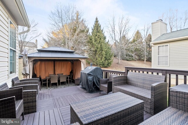 wooden deck featuring a gazebo, grilling area, and an outdoor living space