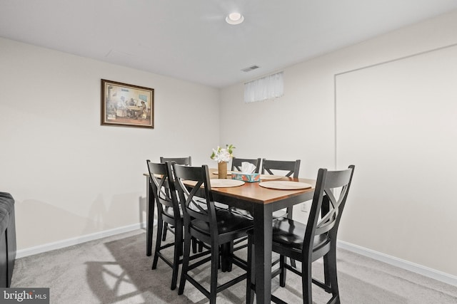 dining space featuring carpet