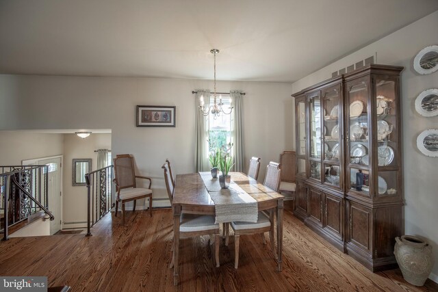 dining room featuring dark hardwood / wood-style flooring and a chandelier