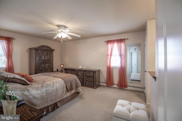 bedroom with light carpet, a baseboard heating unit, and ceiling fan