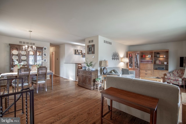 living room with a chandelier and dark hardwood / wood-style flooring