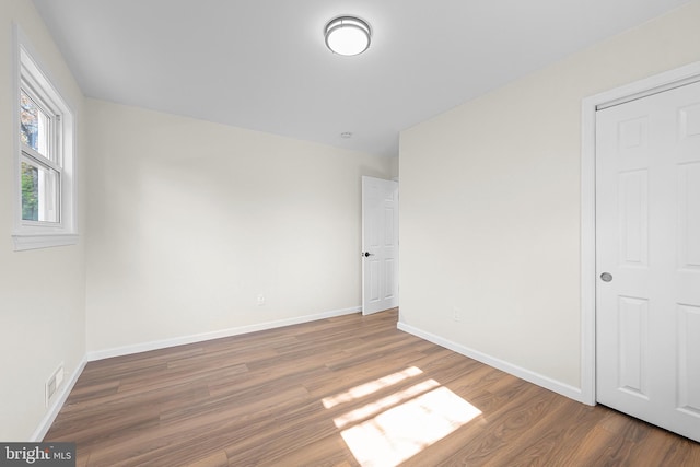 unfurnished bedroom with dark hardwood / wood-style flooring