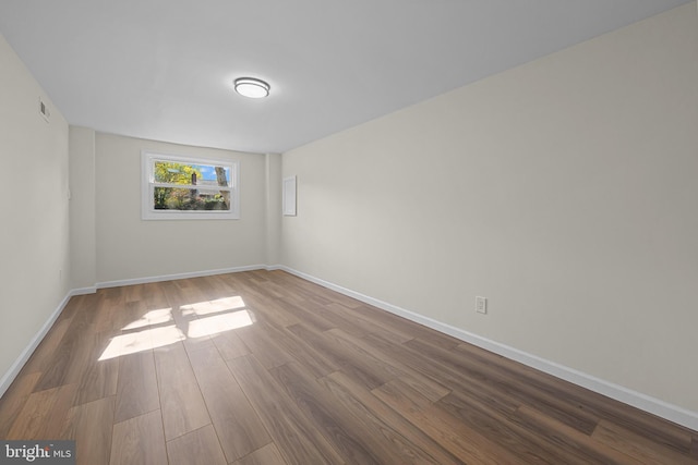 spare room featuring hardwood / wood-style floors