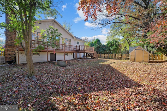 view of yard featuring central AC, a deck, and a shed