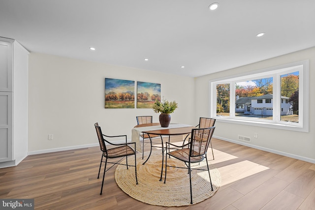 dining space with light wood-type flooring