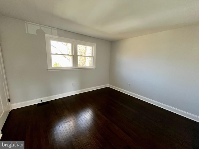 spare room with hardwood / wood-style floors