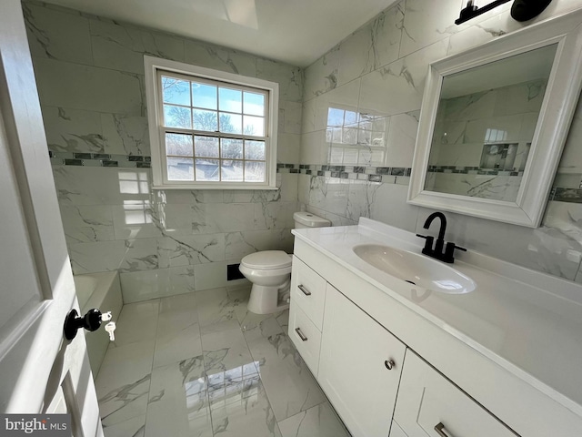 bathroom with vanity, tile walls, and toilet