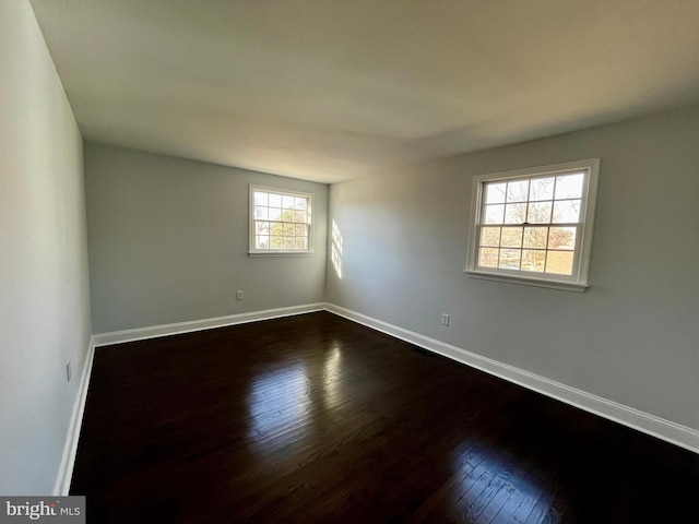 spare room featuring dark hardwood / wood-style flooring