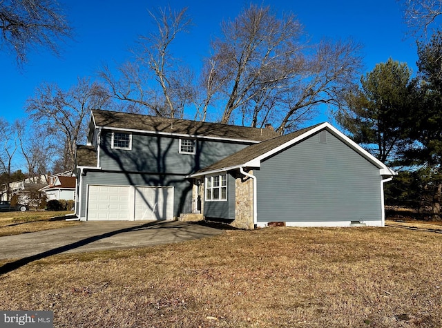 view of front of house with a garage and a front lawn