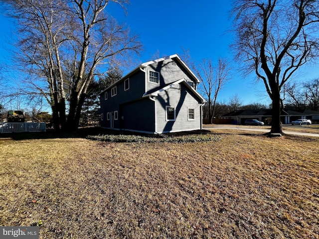 view of property exterior featuring a lawn