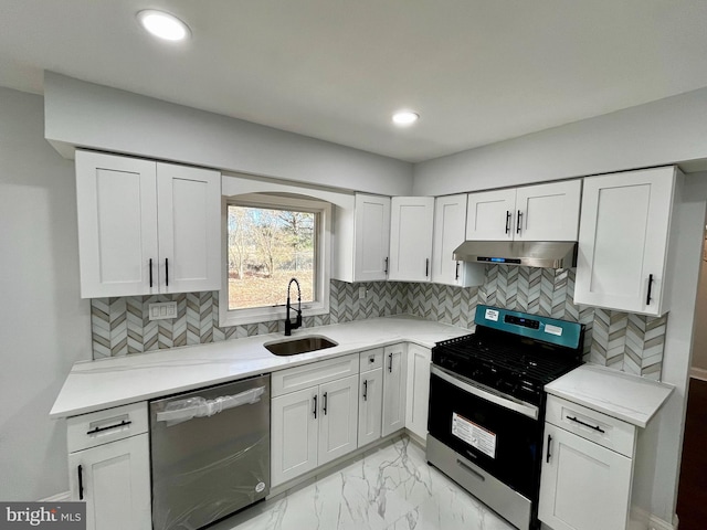 kitchen with sink, backsplash, white cabinets, and appliances with stainless steel finishes