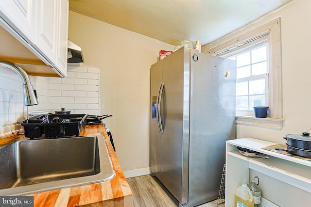 813 Greenhill Rd, Sharon Hill, PA 19079 - kitchen with stainless steel refrigerator with ice dispenser, sink, white cabinetry, tasteful backsplash, and wooden counters