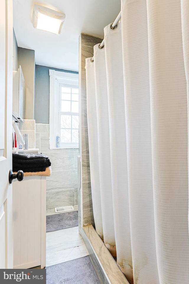 813 Greenhill Rd, Sharon Hill, PA 19079 - bathroom featuring walk in shower and tile walls