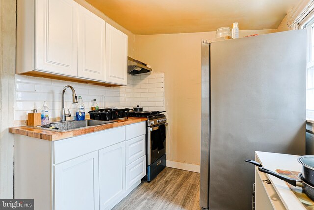 813 Greenhill Rd, Sharon Hill, PA 19079 - kitchen with sink, appliances with stainless steel finishes, white cabinetry, tasteful backsplash, and wood counters