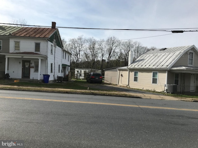 view of side of home with central AC