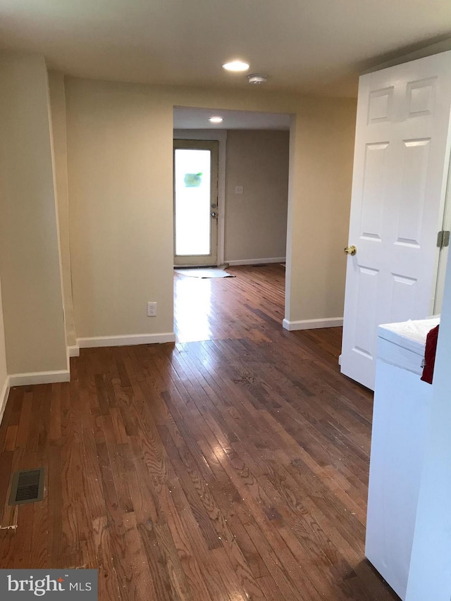 spare room with dark hardwood / wood-style flooring