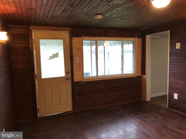 entryway with wood ceiling, dark hardwood / wood-style flooring, and wood walls